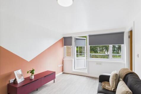 Bright, modern living room with a large window ...