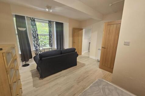 Spacious master bedroom featuring a comfortable...