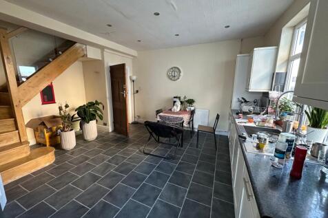 Open-plan kitchen and dining area with modern d...