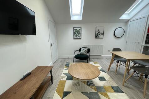 A bright and stylish large modern living room p...