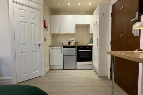 A modern and well-maintained kitchenette with a...