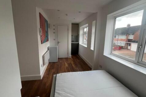 Bright, simply furnished bedroom with a large s...