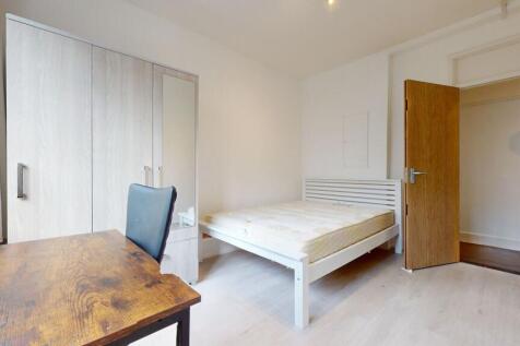Bright bedroom with ample storage and study des...