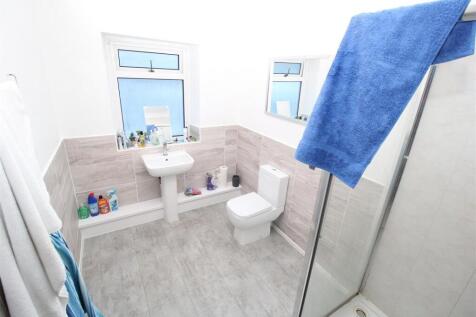 Bright modern bathroom with a walk-in shower...