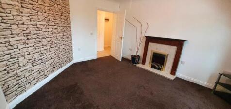 Cosy lounge with feature wall and fireplace...