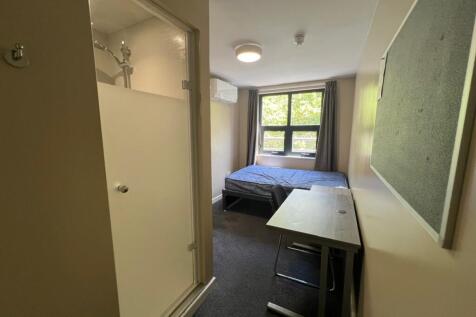 Neat single bedroom with a study desk, comforta...