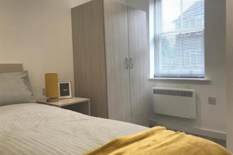 Bright bedroom with modern wardrobe and storage...