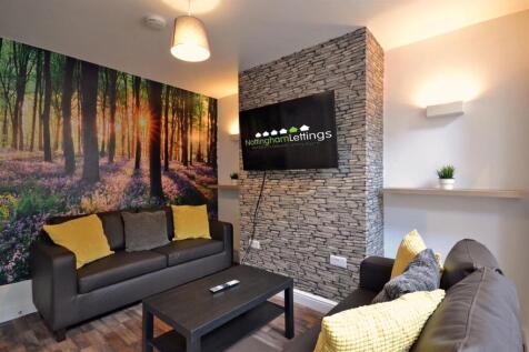 Stylish lounge with feature wall and large TV...