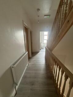 Bright upstairs hallway with wood-effect floori...