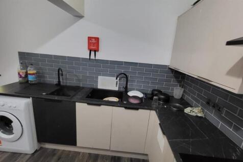 Modern kitchen with washing machine and double ...