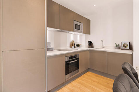 Explore this sleek urban kitchen, perfect for culinary adventures and intimate gatherings.