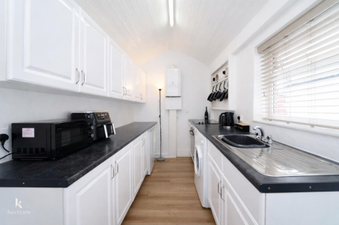 Bright modern galley kitchen design.png