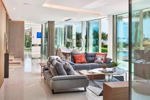 The image shows a modern, open-plan living and din