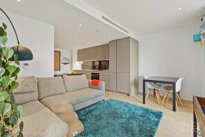 Modern open-plan living space with a cozy sofa, co