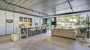 A modern, open-plan kitchen and living area with s