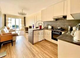 A cozy open-plan kitchen and living area with mode