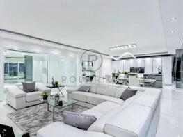 Modern, sleek living room with white furniture, a 