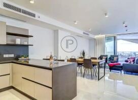 The image shows a modern, open-plan living space f