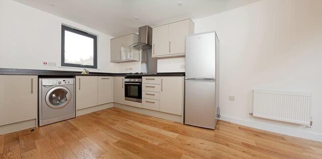Modern kitchen with sleek appliances and storag...