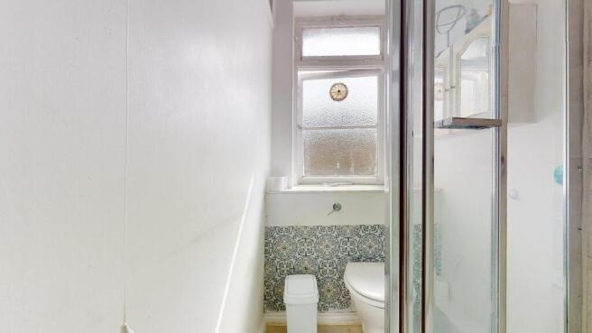 Bright bathroom with unique patterned tiling....