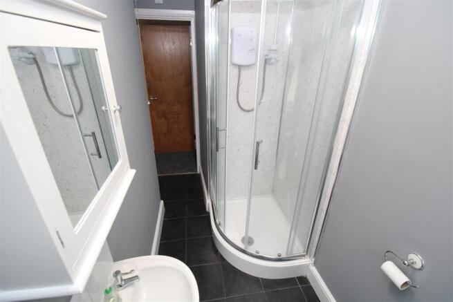 Sleek modern bathroom with walk-in corner showe...