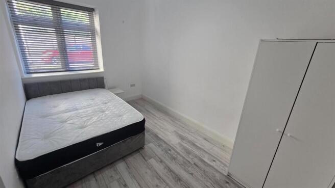 Bright modern bedroom with double bed and wardr...