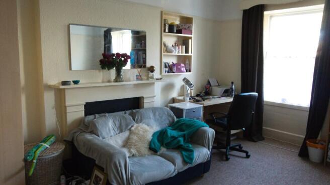 A cozy and inviting living room with ample natu...