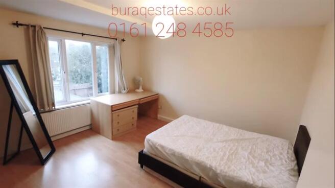 Bright, simply furnished double bedroom with a ...
