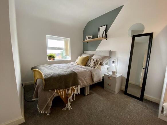 A cozy and well-lit double bedroom with stylish...