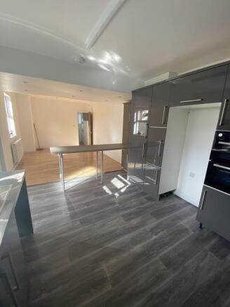 Modern kitchen with sleek grey cabinetry, ample...