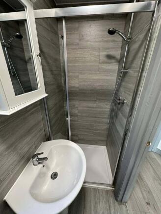 Modern tiled shower room with sleek grey finish...