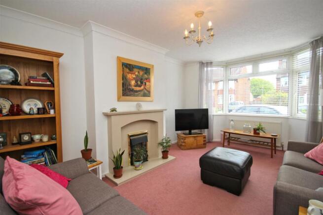 Lounge with walk in bay window and fireplace.jpg