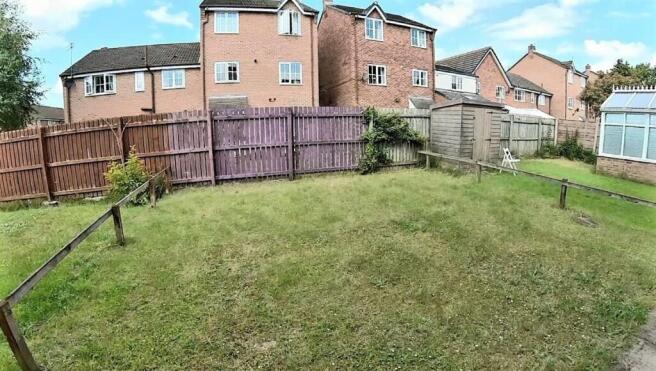 Private rear garden with a level lawn, fenced b...