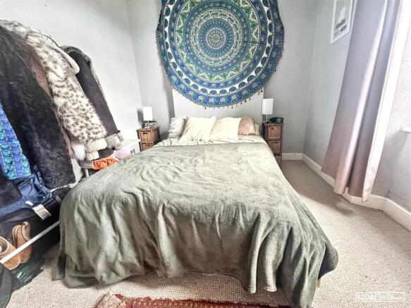 Cosy double bedroom with stylish wall hanging...
