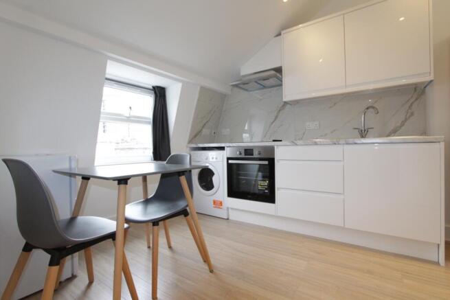 Sleek modern kitchen with bright dining space...