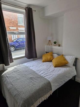 Bright bedroom with stylish ochre cushions...