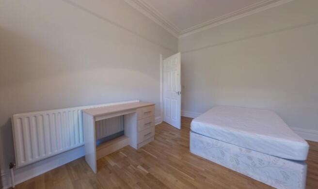 A clean and well-maintained bedroom with ample ...