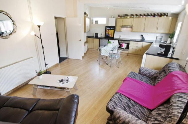 Bright open-plan living area with a fitted kitc...