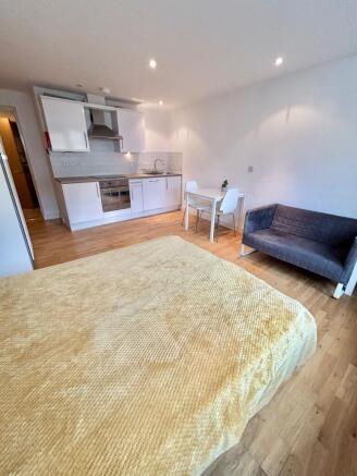 Bright studio space with modern kitchen and sof...