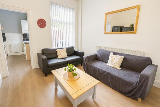 Bright, tidy living room with two comfortable s...