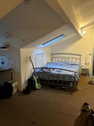 Charming attic bedroom with skylight and desk...