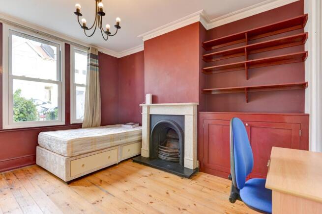 A bright and cozy master bedroom featuring a co...