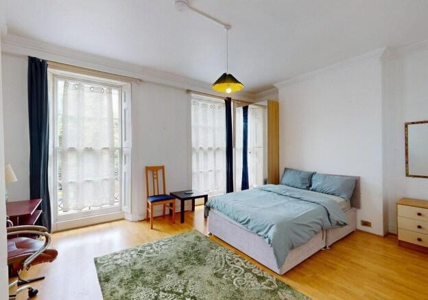Bright, spacious bedroom with large windows...