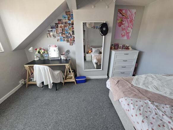 A bright and cozy master bedroom featuring a co...