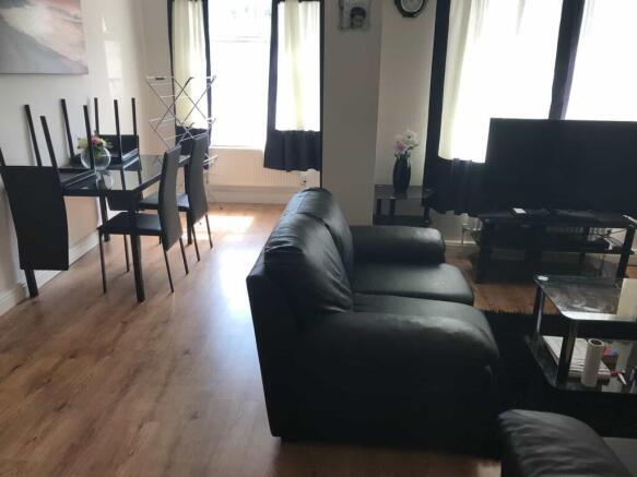 A spacious and modern living room with large wi...