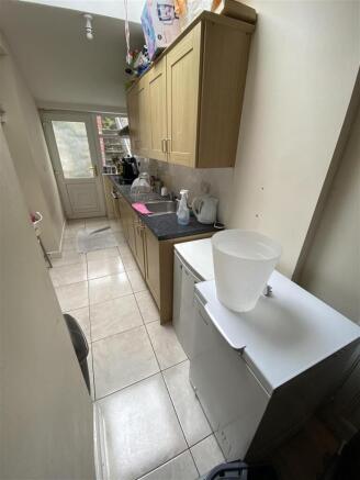 Bright galley kitchen with tiled flooring...