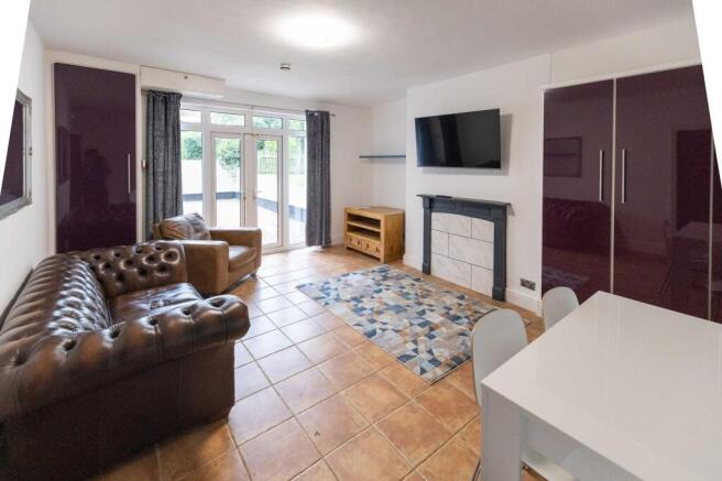 Bright and spacious living room featuring comfo...