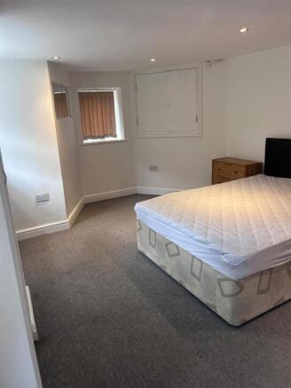 Spacious modern bedroom with plush grey carpet ...