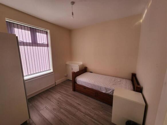 Neat single bedroom with a window letting in na...