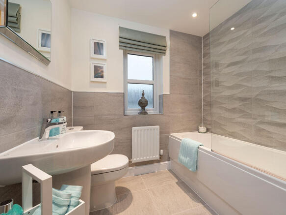 Extensively tiled family bathroom